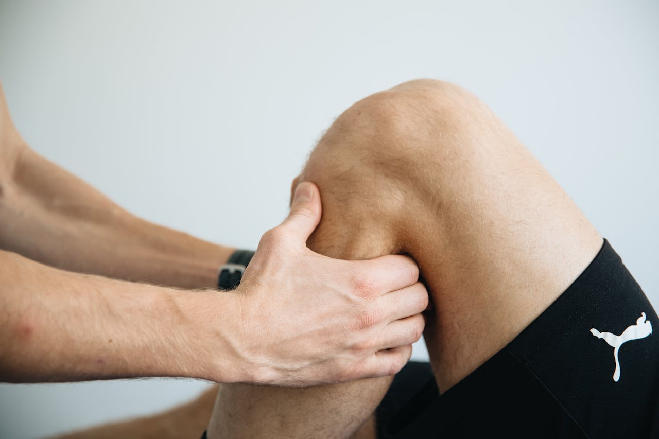 The Art of Drawing Readers In: Your attractive post title goes here Detailed image of a physiotherapy session focusing on knee massage treatment.